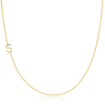 A yellow gold necklace with an S letter charm on a white background. 