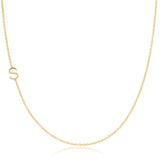 A yellow gold necklace with an S letter charm on a white background. 