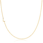 A yellow gold necklace with a L letter charm on a white background. 