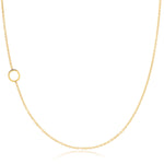 A yellow gold necklace with an O letter charm on a white background. 