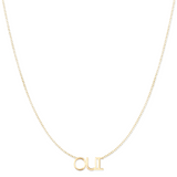 An OUI Necklace in yellow gold on a cable chain on a white background. 