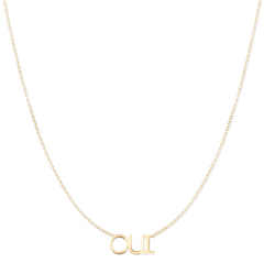 An OUI Necklace in yellow gold on a cable chain on a white background. 