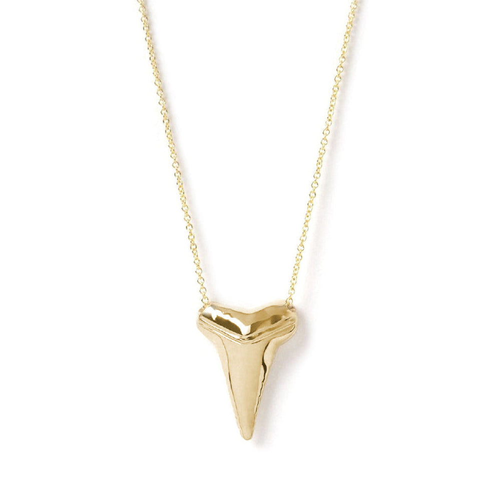 A Sharktooth Necklace in yellow gold on a white background. 