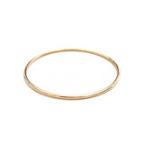 A yellow gold Simple Bangle on a white background. 