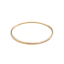 A yellow gold Simple Bangle on a white background. 
