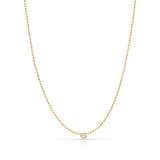 A Single Diamond Layering Necklace in yellow gold on a white background. 