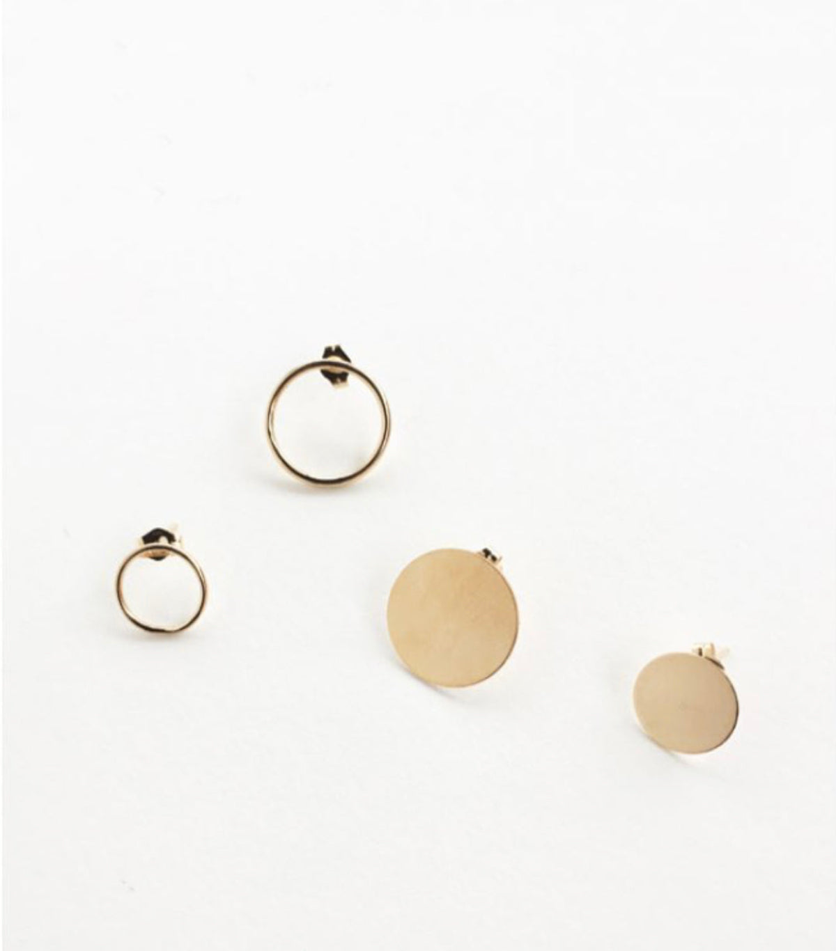Two Open Eclipse Earrings (one small and one large) and two Solid Eclipse Earrings (one small and one large), all in yellow gold, on a white background.