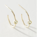 A pair of white gold Birthstone Hoops in August - Peridot against a light grey background. 