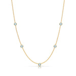 A Quintet Birthstone Layering Necklace - Yellow Gold in Aquamarine - March on a white background.