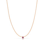 A Single Birthstone Layering Necklace - Rose Gold in Ruby on a white background.