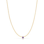 A Single Birthstone Layering Necklace - Yellow Gold in Amethyst - February on a white background.