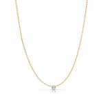 A Single Birthstone Layering Necklace - Yellow Gold in Aquamarine - March on a white background.