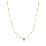 A Single Birthstone Layering Necklace - Yellow Gold in Emerald - May on a white background.