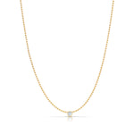 A Single Birthstone Layering Necklace - Yellow Gold in Moonstone - June on a white background.