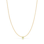 A Single Birthstone Layering Necklace - Yellow Gold in Peridot - August on a white background.