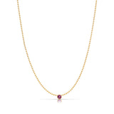 A Single Birthstone Layering Necklace - Yellow Gold in Ruby - July on a white background.