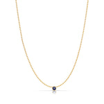 A Single Birthstone Layering Necklace - Yellow Gold in Sapphire - September on a white background.