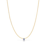 A Single Birthstone Layering Necklace - Yellow Gold in Tanzanite - December on a white background.