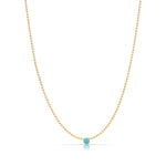A Single Birthstone Layering Necklace - Yellow Gold in Turquoise - December on a white background.