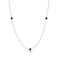 A Triple Birthstone Layering Necklace - White Gold in Garnet - January on a white background.