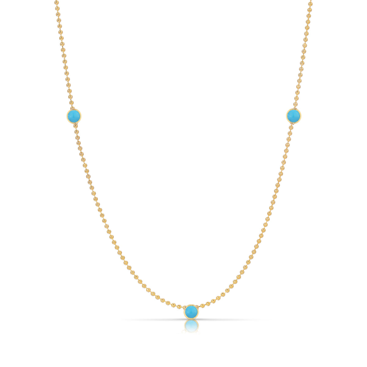 A Triple Birthstone Layering Necklace - Yellow Gold in Turquoise - December on a white background.