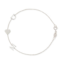 A white gold Custom Gold Bracelet – 3 Letters with the letters D and M and a heart charm, on a white background. 