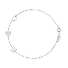 A white gold Custom Gold Bracelet – 3 Letters with the letters D and M and a heart charm, on a white background. 