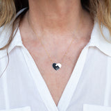 Close-up of a woman's decellotage wearing an Enamel Gold Unity Pendant - Large with a white shirt. 