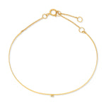 An Off the Cuff Bracelet in yellow gold on a white background. 
